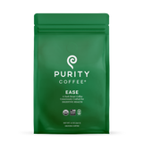 Showcases a green bag of Purity Coffee Ease, a dark roast ground coffee consciously crafted for digestive health.
