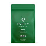 Purity Coffee advertises their "Ease" dark roast whole bean coffee, consciously crafted for digestive health, on a green USDA Organic and bird-friendly certified bag.