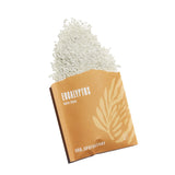 Eucalyptus bath soak spills from its decorative package, inviting relaxation.
