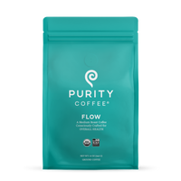 Purity Coffee Flow medium roast, packaged in a teal bag, offers consciously crafted organic ground coffee.
