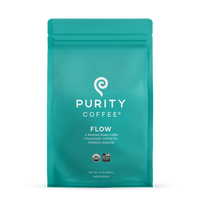 Showcases a teal bag of Purity Coffee Flow, a medium roast whole bean coffee crafted for health and certified organic and bird-friendly.