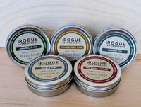 Rogue Evergreens offers small-batch beard balm in Douglas-Fir, Ponderosa Pine, Grand Fir, Noble Fir, and Incense Cedar scents, crafted from wild-harvested boughs in Ashland, Oregon.
