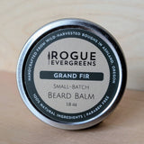 Showcases a tin of Rogue Evergreens Grand Fir beard balm made with wild-harvested ingredients in Ashland, Oregon.
