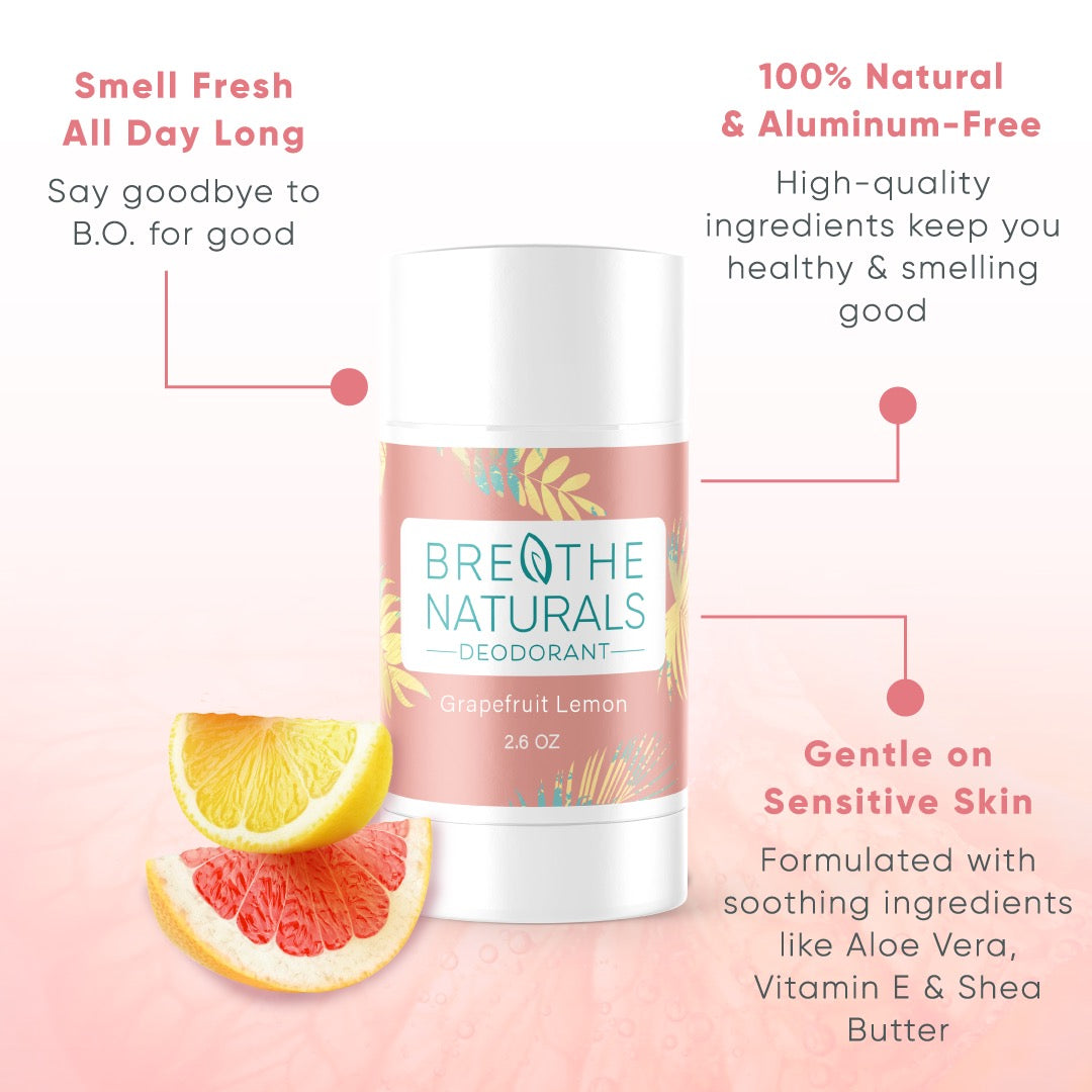 Breathe Naturals Grapefruit Lemon deodorant sits beside sliced grapefruit and lemon, advertising its natural ingredients for sensitive skin.
