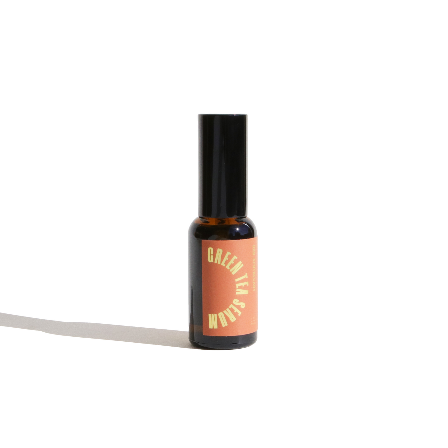 Still life shows a bottle of Green Tea Serum against a bright white background.
