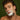 Man shaving his face with a razor against a green background