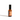 Still life shows an amber glass bottle of lavender milky oat aromatherapy spray against a white background.
