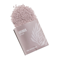 Lavender bath soak spills from its URB Apothecary package.
