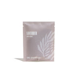 Urb Apothecary sells lavender bath soak in a pale gray package with a leaf design.
