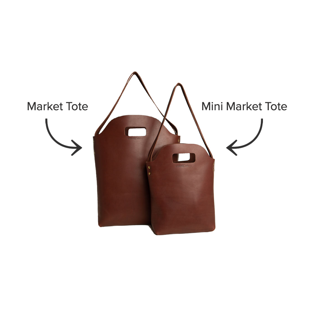 Two brown leather market totes, one full-sized and one mini, sit side-by-side against a white background.
