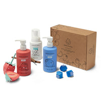 Dabble & Dollop presents a kids' bath product set featuring strawberry, vanilla, and blueberry scented body wash and shampoo, alongside adorable paper fruit decorations, and a gift box.
