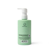 A green bottle of Dabble & Dollop 3-in-1 shampoo, bubble bath, and body wash stands against a white background, promoting its all-natural, tear-free, and cruelty-free formula.

