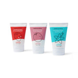 Three Dabble & Dollop hydrating lotions in strawberry, coconut, and vanilla flavors stand against a white background.
