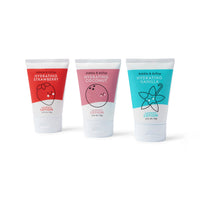 Three Dabble & Dollop hydrating lotions in strawberry, coconut, and vanilla flavors stand against a white background.
