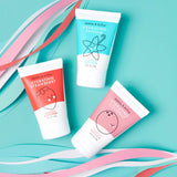 Dabble & Dollop displays their hydrating hand lotions in strawberry, vanilla, and coconut scents against a teal background with colorful paper ribbons.
