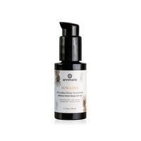 Annmarie Sun Love Everyday Sheer Sunscreen SPF 20 sits upright in a black pump bottle against a white background.
