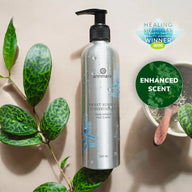 Annmarie's Sweet Sunrise Conditioner bottle, an Earth Day Beauty Awards winner, features an enhanced scent and sits alongside lush greenery.
