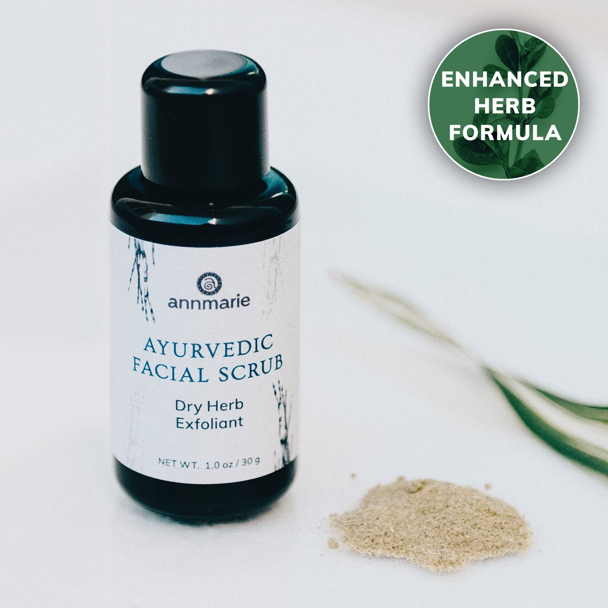 Annmarie Ayurvedic Facial Scrub, a dry herb exfoliant with an enhanced formula, sits beside a small pile of the product.
