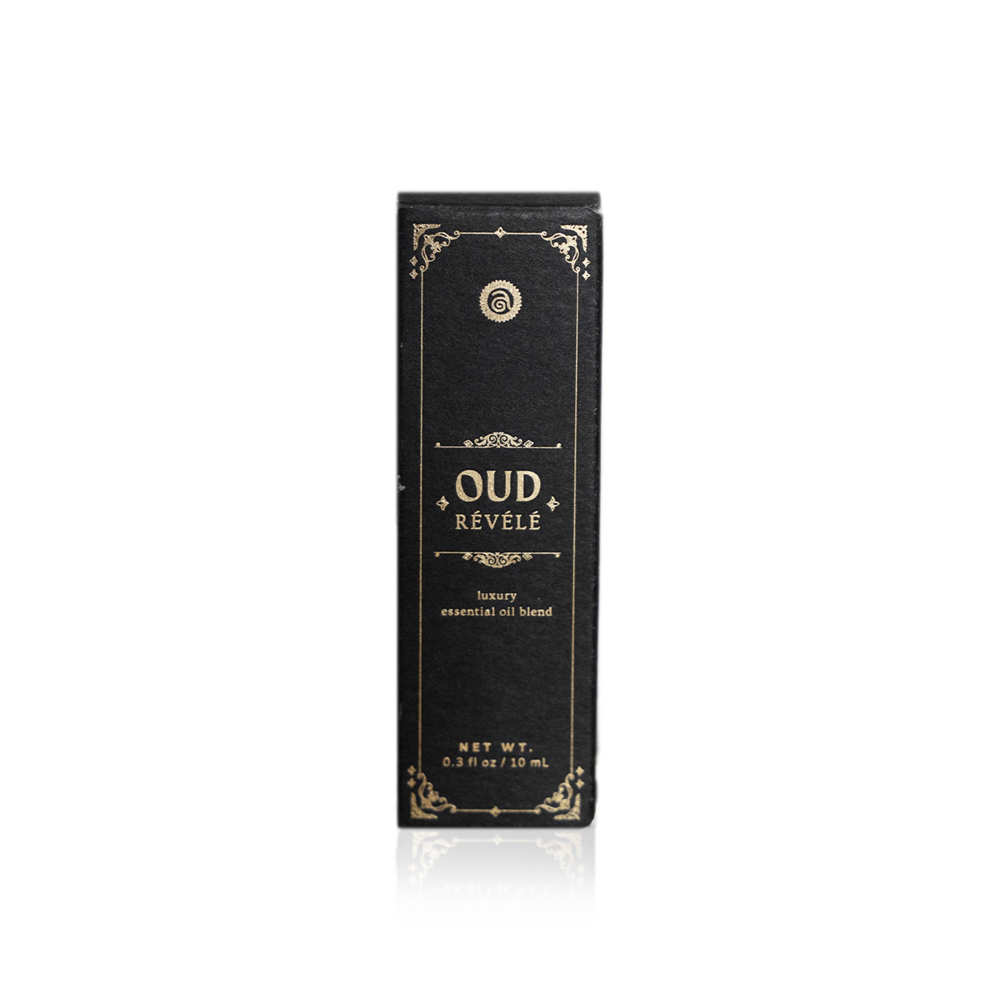 Showcases the elegant Oud Révélé luxury essential oil blend packaging.
