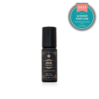 Shows a bottle of award-winning Oud Révélé perfume, a luxury essential oil blend recognized in the 2022 Clean Beauty Awards.
