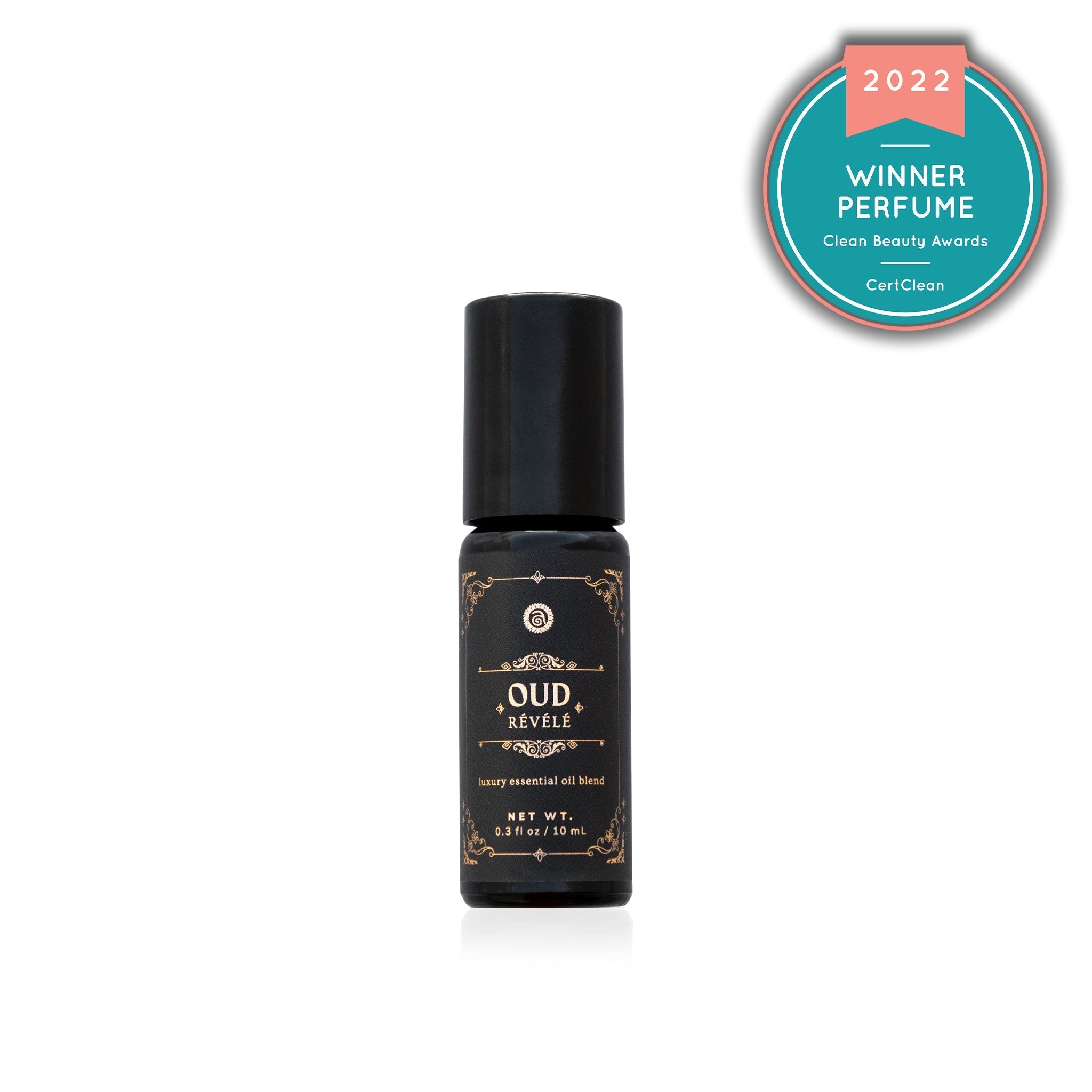 Shows a bottle of award-winning Oud Révélé perfume, a luxury essential oil blend recognized in the 2022 Clean Beauty Awards.
