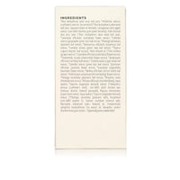 Close-up displays the skincare product's ingredient list, highlighting aloe vera, green tea, and plant-based extracts for a natural beauty formulation.
