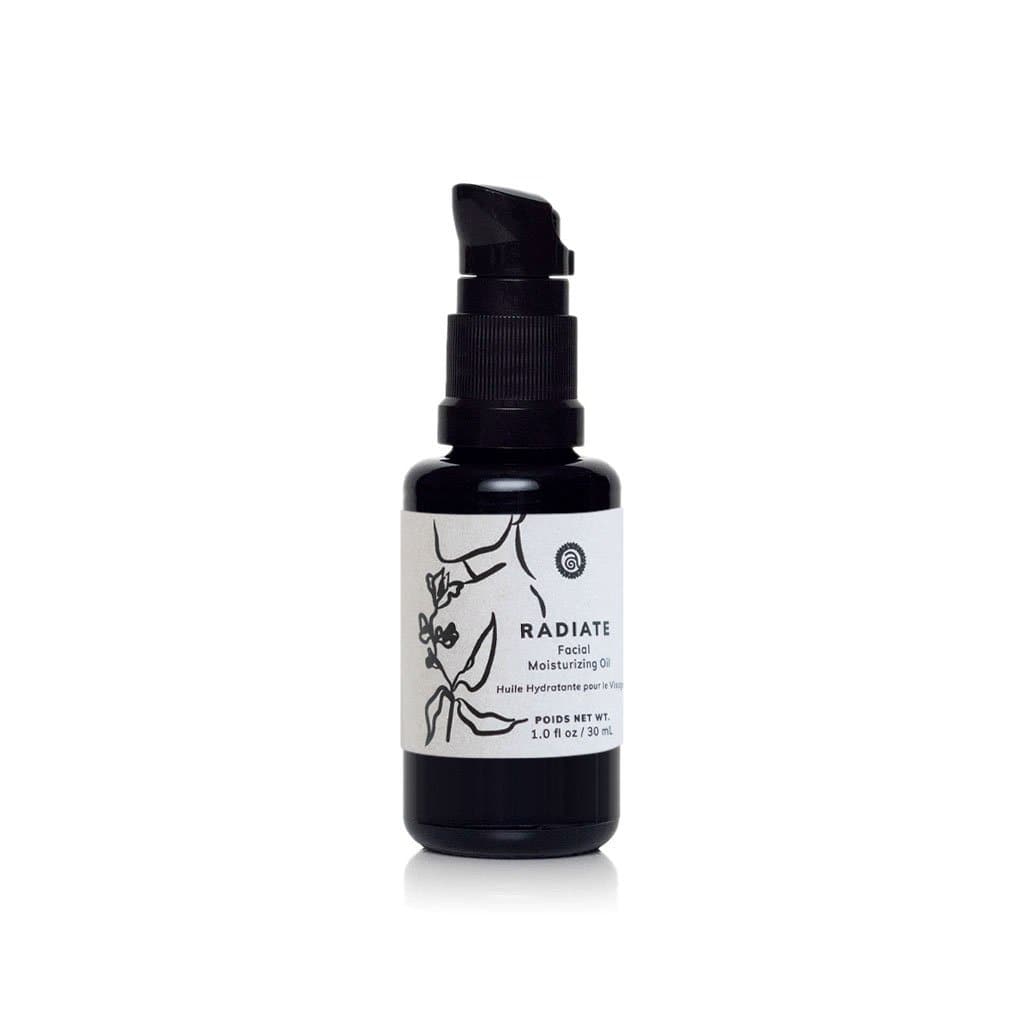 Bottle of Radiate Facial Moisturizing Oil sits on a white surface.
