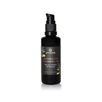 Annmarie's Restorative Cleansing Oil in a black bottle features manuka-infused ingredients for gentle face cleansing.
