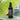 Annmarie's Restorative Cleansing Oil bottle sits on a green banana leaf, promoting its natural skincare benefits.
