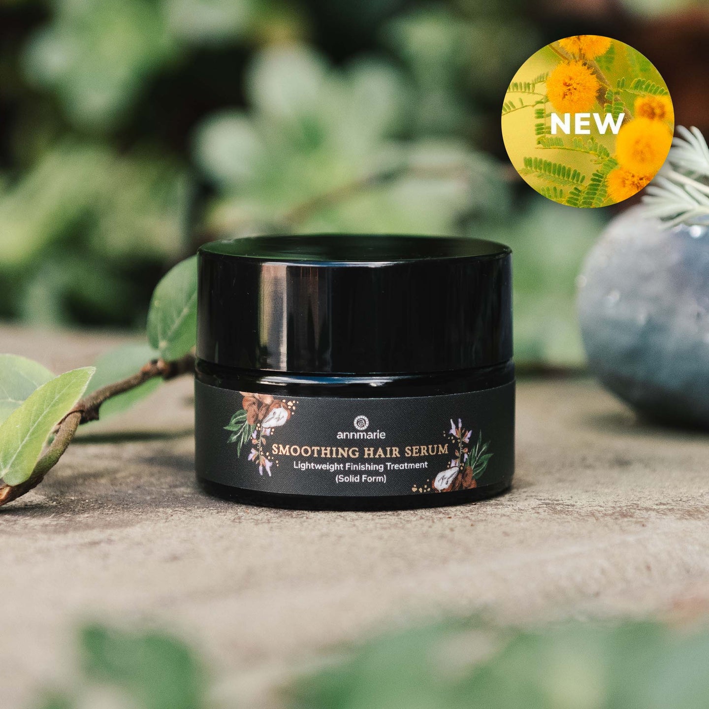 Annmarie Smoothing Hair Serum jar sits outdoors, promoting the new, lightweight finishing treatment.
