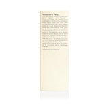 Close-up shows the ingredients list, featuring both scientific and common names of naturally derived oils and plant extracts, for a beauty or skincare product.
