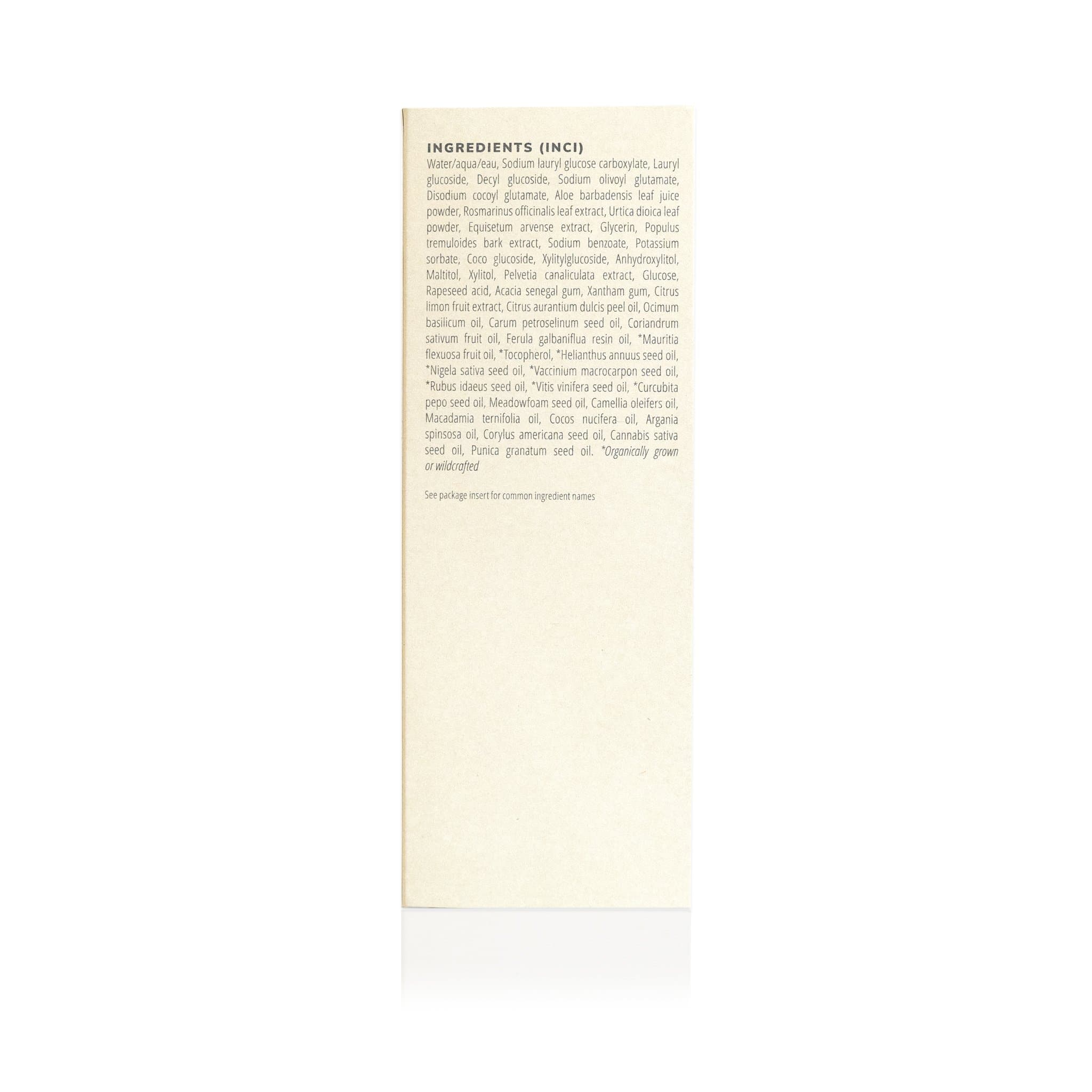 Close-up shows the ingredients list, featuring both scientific and common names of naturally derived oils and plant extracts, for a beauty or skincare product.
