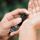 A person pumps Annmarie Wild Fruit Serum onto their hand.

