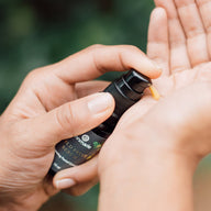 A person pumps Annmarie Wild Fruit Serum onto their hand.
