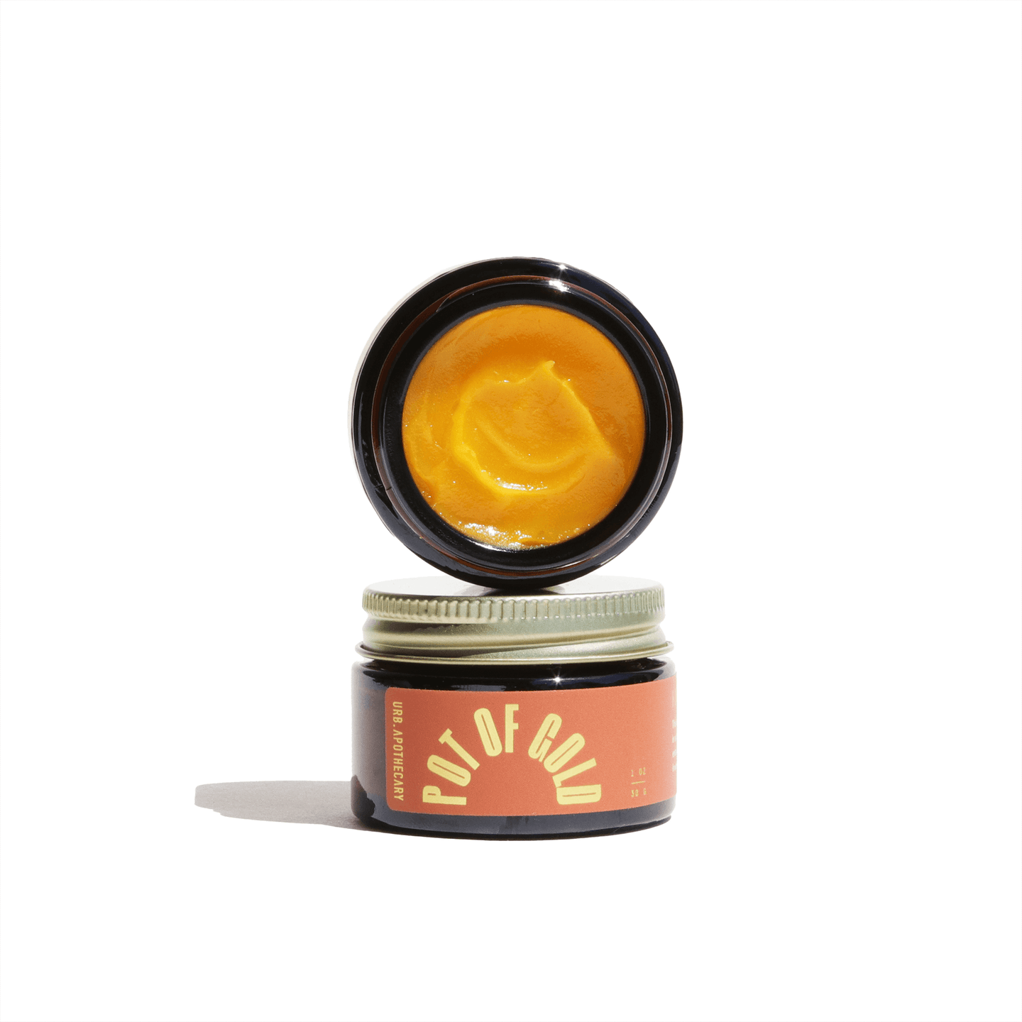 Apothecary displays stacked jars of Pot of Gold healing balm.
