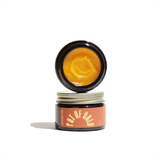 Apothecary displays stacked jars of Pot of Gold healing balm.
