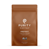 Purity Coffee displays its Protect light-medium roast whole bean coffee in an organic USDA certified and Bird Friendly sealed brown bag.
