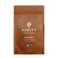 Purity Coffee displays its Protect light-medium roast whole bean coffee in an organic USDA certified and Bird Friendly sealed brown bag.
