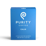Showcases a blue box of Purity Coffee Calm, highlighting its brand and the product's calming properties.