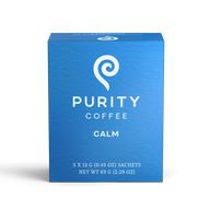 Showcases a blue box of Purity Coffee Calm, highlighting its brand and the product's calming properties.