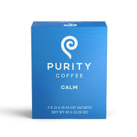 Showcases a blue box of Purity Coffee Calm, highlighting its brand and the product's calming properties.