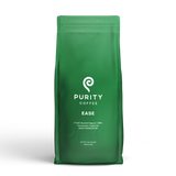Purity Coffee sells their "Ease" blend, a dark roasted organic coffee crafted for easy digestion, in a green bag.
