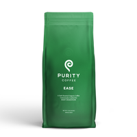 Purity Coffee sells their "Ease" blend, a dark roasted organic coffee crafted for easy digestion, in a green bag.
