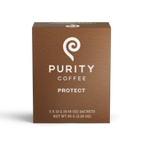 Purity Coffee's brown box promotes its "Protect" blend with a white spiral logo and promises of consciously crafted liver vitality.
