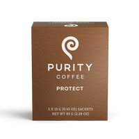 Purity Coffee's brown box promotes its "Protect" blend with a white spiral logo and promises of consciously crafted liver vitality.
