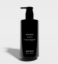 Jack Henry's black bottle presents its Hinoki Cypress shampoo designed to cleanse and strengthen hair.
