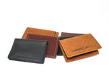 Display showcases an assortment of handcrafted leather wallets in varying colors and textures by Urban Southern.

