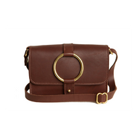 A stylish brown leather crossbody bag features a gold circular handle and strap buckle.
