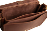 Open brown leather satchel reveals soft suede interior and multiple compartments.

