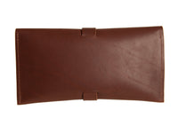 A brown leather envelope-style wallet features a simple strap closure.
